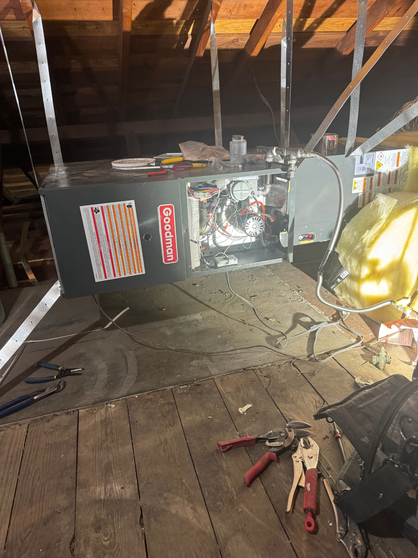 Furnace with the service panel removed showing the inducer, gas valve, and control wiring