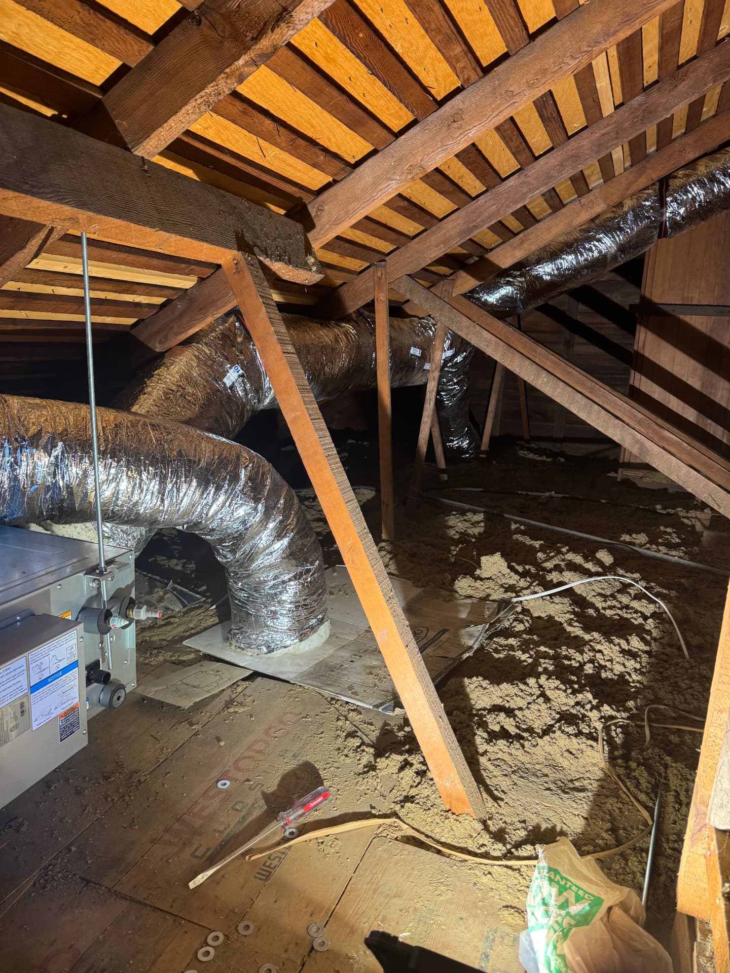 New insulated duct runs routed through an attic to supply registers